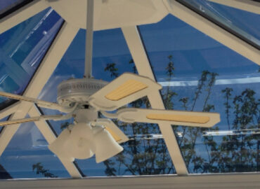 Interior view of a conservatory with solar control window film installed on the roof and windows to improve comfort during warmer weather.
