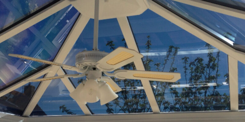 Interior view of a conservatory with solar control window film installed on the roof and windows to improve comfort during warmer weather.