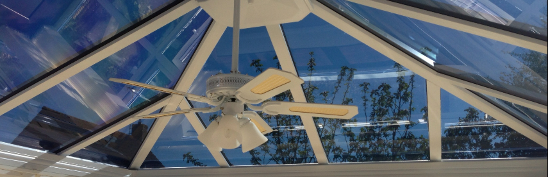Interior view of a conservatory with solar control window film installed on the roof and windows to improve comfort during warmer weather.